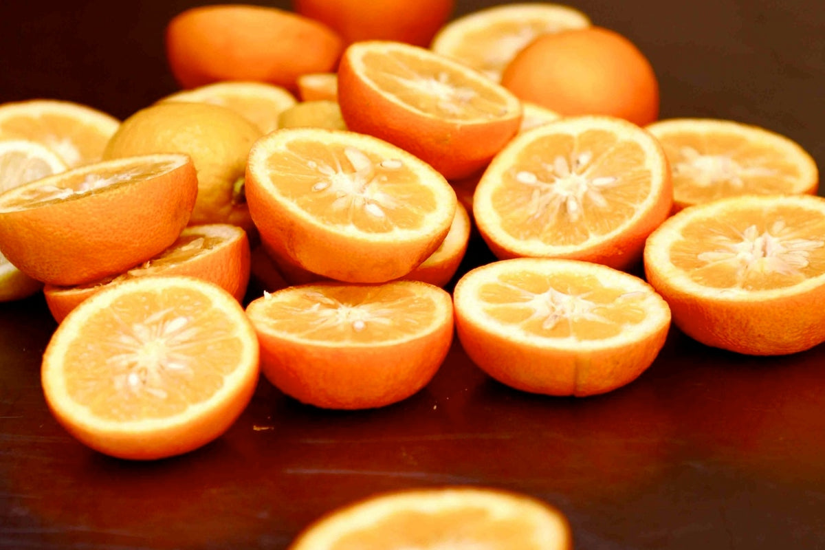 a photo depicting half sliced oranges: bitter orange extract
