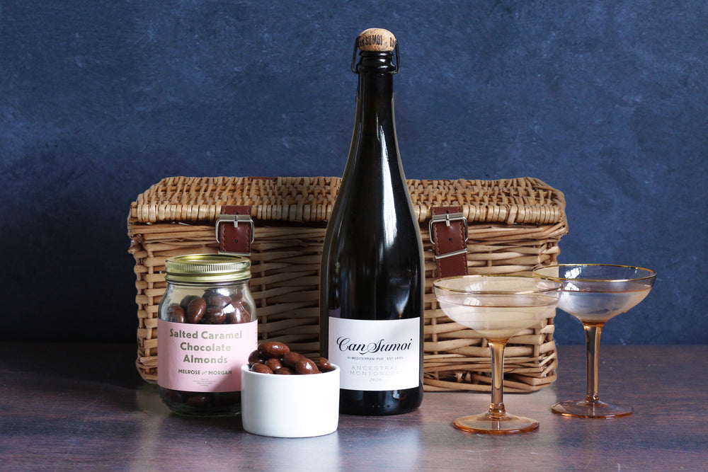 The Chocolate and Bubbles Hamper contains a bottle of the wonderful Ancestral Montonega Pet-Nat 2018 Can Sumoi with our best selling Salted Caramel Almond Jar, all beautifully wrapped and packaged in a signature Melrose and Morgan hamper box.